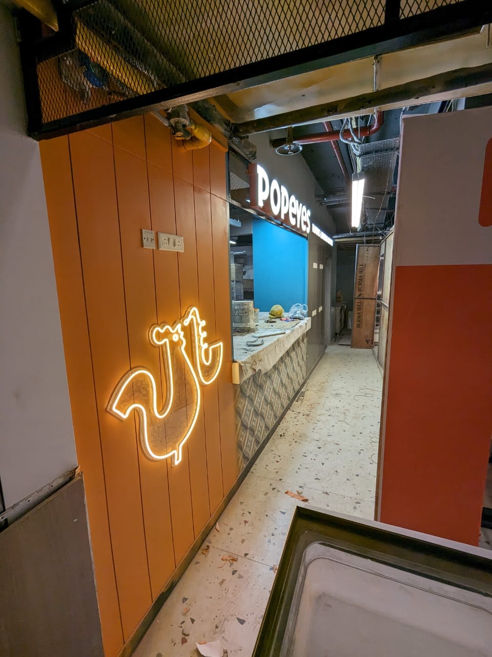 Popeyes franchise fit-out — neon signage and interior branding